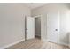 This bedroom has neutral walls, and wood-look flooring, with two doors for multiple entry ways at 1505 W Fillmore St, Phoenix, AZ 85007