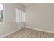 This bedroom has neutral walls, and wood-look flooring, with a window with coverings at 1505 W Fillmore St, Phoenix, AZ 85007