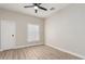 The bedroom features wood-look flooring, neutral walls, a ceiling fan, and a window for natural light at 1505 W Fillmore St, Phoenix, AZ 85007