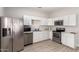 Well-lit kitchen featuring sleek white cabinets and stainless steel appliances at 1505 W Fillmore St, Phoenix, AZ 85007