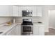 This is a kitchen with white cabinets and stainless steel appliances, including a microwave and stove at 1505 W Fillmore St, Phoenix, AZ 85007