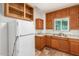 A kitchen with wood cabinets and a white refrigerator offers space to cook at 1505 W Fillmore St, Phoenix, AZ 85007