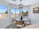 Charming breakfast nook with modern light fixture and bright windows showcasing the outdoor view at 1612 E Desert Rose Trl, San Tan Valley, AZ 85143