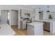 Spacious kitchen with stainless steel appliances, gray cabinets, and a center island, great for cooking at 1612 E Desert Rose Trl, San Tan Valley, AZ 85143