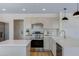 Modern kitchen featuring stainless steel appliances, light cabinetry, and quartz countertops at 1612 E Desert Rose Trl, San Tan Valley, AZ 85143