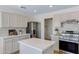 Well-appointed kitchen with stainless steel appliances, white cabinetry, and ample countertop space for cooking at 1612 E Desert Rose Trl, San Tan Valley, AZ 85143