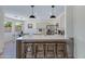 Modern kitchen featuring a large island with seating, pendant lights, and open access to other living spaces at 1612 E Desert Rose Trl, San Tan Valley, AZ 85143