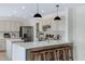Bright kitchen boasts quartz countertops, stainless steel appliances, and bar seating at 1612 E Desert Rose Trl, San Tan Valley, AZ 85143