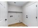 Well-lit laundry room featuring ample shelving and utility connections at 1612 E Desert Rose Trl, San Tan Valley, AZ 85143