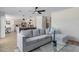 Open-concept living room with contemporary furnishings and adjacent kitchen at 1612 E Desert Rose Trl, San Tan Valley, AZ 85143