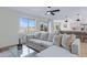 Bright and open living room flows to the kitchen and backyard, featuring a sectional and natural light at 1612 E Desert Rose Trl, San Tan Valley, AZ 85143