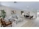 Spacious living room with modern decor, wood-look flooring, and ample natural light at 1612 E Desert Rose Trl, San Tan Valley, AZ 85143