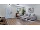 Cozy living room with a comfortable gray sofa, accent chair, stylish rug, and a bright window view at 1612 E Desert Rose Trl, San Tan Valley, AZ 85143