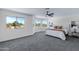 Sunlit main bedroom with large windows, neutral colors, and ceiling fan at 1612 E Desert Rose Trl, San Tan Valley, AZ 85143