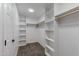 Bright walk-in closet with shelving, rod, and neutral carpet at 1612 E Desert Rose Trl, San Tan Valley, AZ 85143