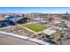 Community amenities from an aerial view including a pool, playground, community center, and open spaces at 16928 W Jenan Rd, Surprise, AZ 85388