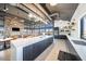 Modern kitchen with stainless steel appliances and a large island with waterfall countertops at 16928 W Jenan Rd, Surprise, AZ 85388