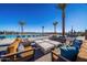 Resort style pool deck with lounge seating and views of the community and surrounding landscape at 16928 W Jenan Rd, Surprise, AZ 85388
