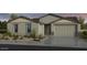 Attractive single-story home featuring a two-car garage and well-maintained landscaping at 17110 W Hackamore Dr, Surprise, AZ 85387