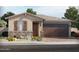 Charming single-story home with a stone accent wall, two car garage, and desert landscaping at 17582 W Adams St, Goodyear, AZ 85338