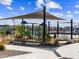 Playground with slides, climbing equipment and tables with shade canopies and landscaping at 17582 W Adams St, Goodyear, AZ 85338