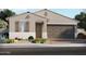 Charming single-story home featuring neutral color palette, shuttered window, and a two-car garage at 17588 W Adams St, Goodyear, AZ 85338