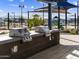 Outdoor grilling area with two stainless steel grills, counter space, and shade structures at 17588 W Adams St, Goodyear, AZ 85338