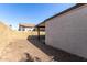 View of the gravel backyard with block wall and covered patio at 1822 S 39Th St # 7, Mesa, AZ 85206