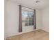 Comfortable bedroom featuring tile flooring and a window with gray curtains, providing natural light at 1822 S 39Th St # 7, Mesa, AZ 85206