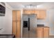 Kitchen features a stainless steel refrigerator and wooden cabinets at 1822 S 39Th St # 7, Mesa, AZ 85206