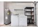 Laundry area in garage with washer, dryer, water heater, and shelving at 1822 S 39Th St # 7, Mesa, AZ 85206
