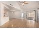 Open living room with wood flooring, kitchen pass-through, and patio access at 1822 S 39Th St # 7, Mesa, AZ 85206