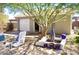 Charming backyard with mature tree, patio and a detached garage offering extra storage at 1837 W Roma Ave, Phoenix, AZ 85015