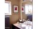 Bathroom featuring a granite countertop vanity and mirrored wall at 1837 W Roma Ave, Phoenix, AZ 85015
