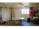 Spacious garage with overhead door, window, extra storage and workbench at 1837 W Roma Ave, Phoenix, AZ 85015
