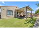 Lush backyard with a covered patio, grill, pool, and comfortable seating, perfect for outdoor enjoyment at 18437 E Celtic Manor Dr, Queen Creek, AZ 85142