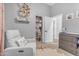 Bright Bedroom featuring a closet, gray walls, a changing table and a comfortable chair at 18437 E Celtic Manor Dr, Queen Creek, AZ 85142