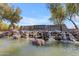 Scenic community entrance showcasing a waterfall feature and the 'Sossaman Estates' sign at 18437 E Celtic Manor Dr, Queen Creek, AZ 85142