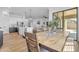 Inviting dining space adjacent to the kitchen featuring an expansive wooden table and views of the backyard at 18437 E Celtic Manor Dr, Queen Creek, AZ 85142