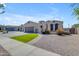 Lovely desert home featuring a well-manicured lawn, attractive xeriscaping, and a convenient two-car garage at 18437 E Celtic Manor Dr, Queen Creek, AZ 85142