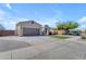 Charming single-story home showcasing a spacious driveway, two-car garage, and inviting desert landscaping at 18437 E Celtic Manor Dr, Queen Creek, AZ 85142