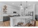 Modern kitchen featuring white cabinetry, quartz countertops, stainless steel appliances, and a stylish island at 18437 E Celtic Manor Dr, Queen Creek, AZ 85142