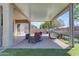 Charming outdoor living space with a grill, brick pavers, and lush synthetic grass at 18437 E Celtic Manor Dr, Queen Creek, AZ 85142
