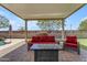 Inviting outdoor living area featuring comfortable seating and a modern fire pit table at 18437 E Celtic Manor Dr, Queen Creek, AZ 85142