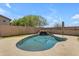 Beautiful pool area with a rock waterfall feature and ample space for recreation at 18437 E Celtic Manor Dr, Queen Creek, AZ 85142
