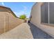 Spacious side yard with gravel, offering functionality and potential for various uses at 18437 E Celtic Manor Dr, Queen Creek, AZ 85142