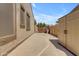 Large side yard with a concrete walkway, potential for extra storage, and easy access to other areas at 18437 E Celtic Manor Dr, Queen Creek, AZ 85142