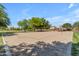 Outdoor sand volleyball court with trees and picnic tables in a well-maintained community park setting at 18437 E Celtic Manor Dr, Queen Creek, AZ 85142