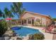 Inviting backyard pool with rock accents, lounge chairs, and covered patio, perfect for outdoor living at 18643 N 73Rd Ave, Glendale, AZ 85308