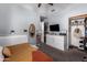 This bedroom features a white dresser with mounted tv and a neat closet at 18643 N 73Rd Ave, Glendale, AZ 85308